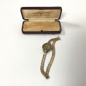 A yellow metal Huber lady's wristwatch on a 9ct gold bookchain strap, marked British Made (12cm) (