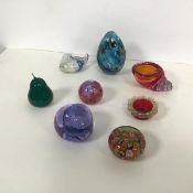 A collection of glass ornaments including a Caithness pebble, a millefiore paperweight, a glass