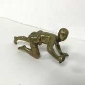 A bronzed brass figure of a Young African Man clutching a handle (14cm x 6cm)