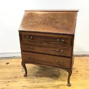 An Edwardian mahogany and satinwood banded fall front bureau, above a fitted interior of drawers and