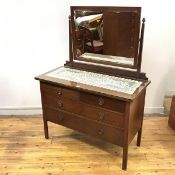 An Edwardian mahogany dressing chest, the raised back incorporating a rectangular bevelled mirror