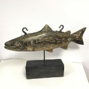 A table top weather vane in the form of a salmon, possibly formerly a shop sign, with two hanging