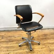 A modern office chair, with swivel base and height adjustor, the vinyl upholstered back and seat