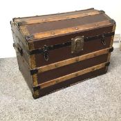An early 20thc. travelling trunk, the canvas frame, with oak and metal straps and brass to