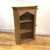 A 19thc stripped pine hanging corner cabinet, the pointed arched door enclosing two shelves (100cm x