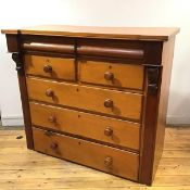 An unusual Victorian ash and mahogany chest of drawers, the inverted breakfront top above a pair