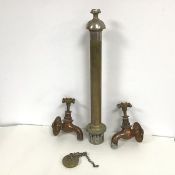A pair of 19thc copper taps with enamel top and plug and cylindrical plug attachment