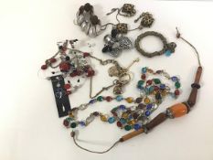 A group of costume jewellery including a long chain with coloured paste gems, mother of pearl