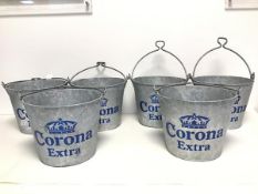 A set of six aluminium drinks buckets, all stamped Corona Extra in large blue letters, handles