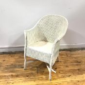 A Lloyd Loom armchair, the woven back, arms and seat supported on turned legs united by