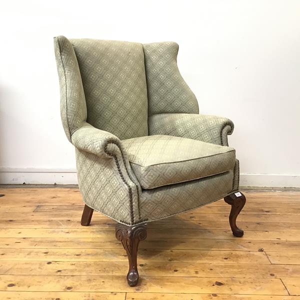 A George II style lug armchair, first half of the 20thc., the back, arms and seat with close