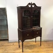 A mahogany cabinet in the American Federal style, first half of the 20thc., the swan neck pediment