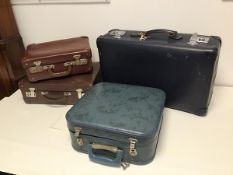 Four vintage travel cases, including two brown leather cases, one blue vinyl and one square