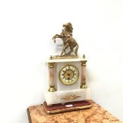 A late 19thc. onyx and gilt metal mounted mantle clock, the circular arabic dial within turned