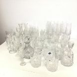 A collection of crystal drinking glasses including champagne flutes, sherry glasses, brandy