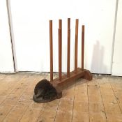 A modern boot stand with eight spars on a base with bracket feet and a boot scrape in the form of