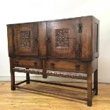 An Arts & Crafts style oak sideboard, c.1920s, the rectangular caddy top above a pair of cupboard