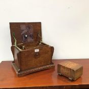 An early 20thc oak sewing box of sarcophagus form, with fitted interior (23cm x 36cm x 25cm) and a