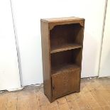 An Edwardian oak bookcase of small proportions, the rectangular top with moulded edge above an