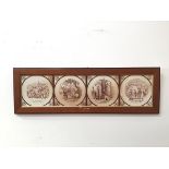 Four Victorian transfer printed tiles depicting Dickensian scenes, mounted in a moulded wooden frame