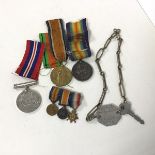 A collection of military medals including two from WWI, The Defence Medal from WWII, three WWI