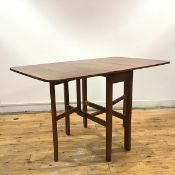 A 1960s dining table, the rectangular top with hinged flaps raised on square section supports (