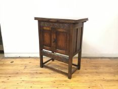 A small oak buffet, c.1920s, in the Arts & Crafts style, the rectangular top with a pair of pull out