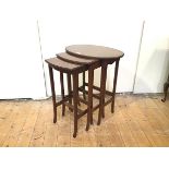 A graduated set of Edwardian mahogany occasional tables, the largest table with oval top and