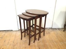 A graduated set of Edwardian mahogany occasional tables, the largest table with oval top and