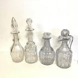 A set of four 19thc. decanters, including a Regency claret jug, a Gothic Bludgeon style decanter and