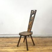 An early 20thc pokerwork spinning chair, the detachable tapering back set into an octagonal seat, on