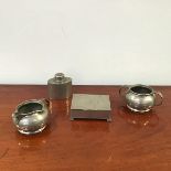 A Liberty Tudric pewter milk jug, sugar bowl and tea cannister, all with beaten textured surface,