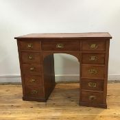 A neat Edwardian walnut desk, the rectangular top above three frieze drawers and two banks of four