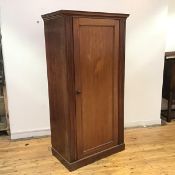 A mid 19thc mahogany hall cupboard, the moulded projecting cornice above a panelled door enclosing