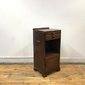 An elm bedside cabinet by Whytock & Reid, Edinburgh the shallow gallery back and oblong top above