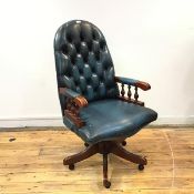 A reproduction buttoned leather and wood desk chair, the hoop shaped back and serpentine fronted