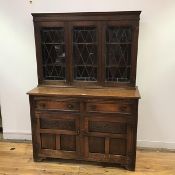 An Ercol style oak dresser, the raised back with hobnail detail and three leaded glazed doors