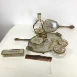 A dressing table set including hand mirror, lamp, brushes, table lighter, footed tray etc., all with