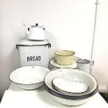 A collection of white enamelled bowls and a plate, pitcher, teapot and bread box (29cm x 34cm x