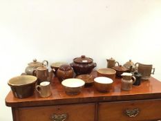 A collection of caramel glazed stoneware items to include storage jars, a part tea and coffee