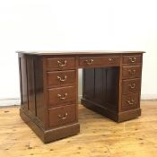 A mahogany pedestal desk, c.1900, the tooled leather writing surface above three frieze drawers