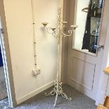 A four arm floor standing candelabrum with multiple C scrolls and a pine cone finial, painted