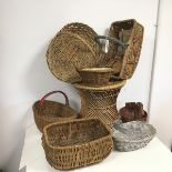 A collection of wicker ware baskets including one in the form of a duck, one with a hinged handle