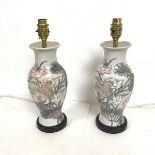 A pair of table lamps of baluster form, with Japanese style decoration of birds, ginkgo biloba and