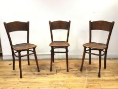 A set of three Austrian bentwood chairs, early 20thc., with unusual reticulated back and seat, on