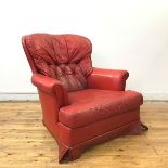 A 1970s red vinyl upholstered button back armchair, the padded back, arms and seat with detachable