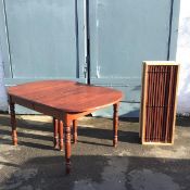 An unusual Amish made extending dining table, the rectangular top with moulded edge and rounded