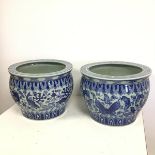 A pair of Chinese fish bowls, one with a central frieze depicting fish amongst aquatic plant life,