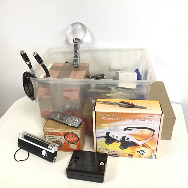 A collection of stamp collector's equipment including magnifiers, two philatector water mark