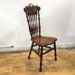 An oak spinning chair, c.1900, possibly American, the scrolling top rail supported by baluster